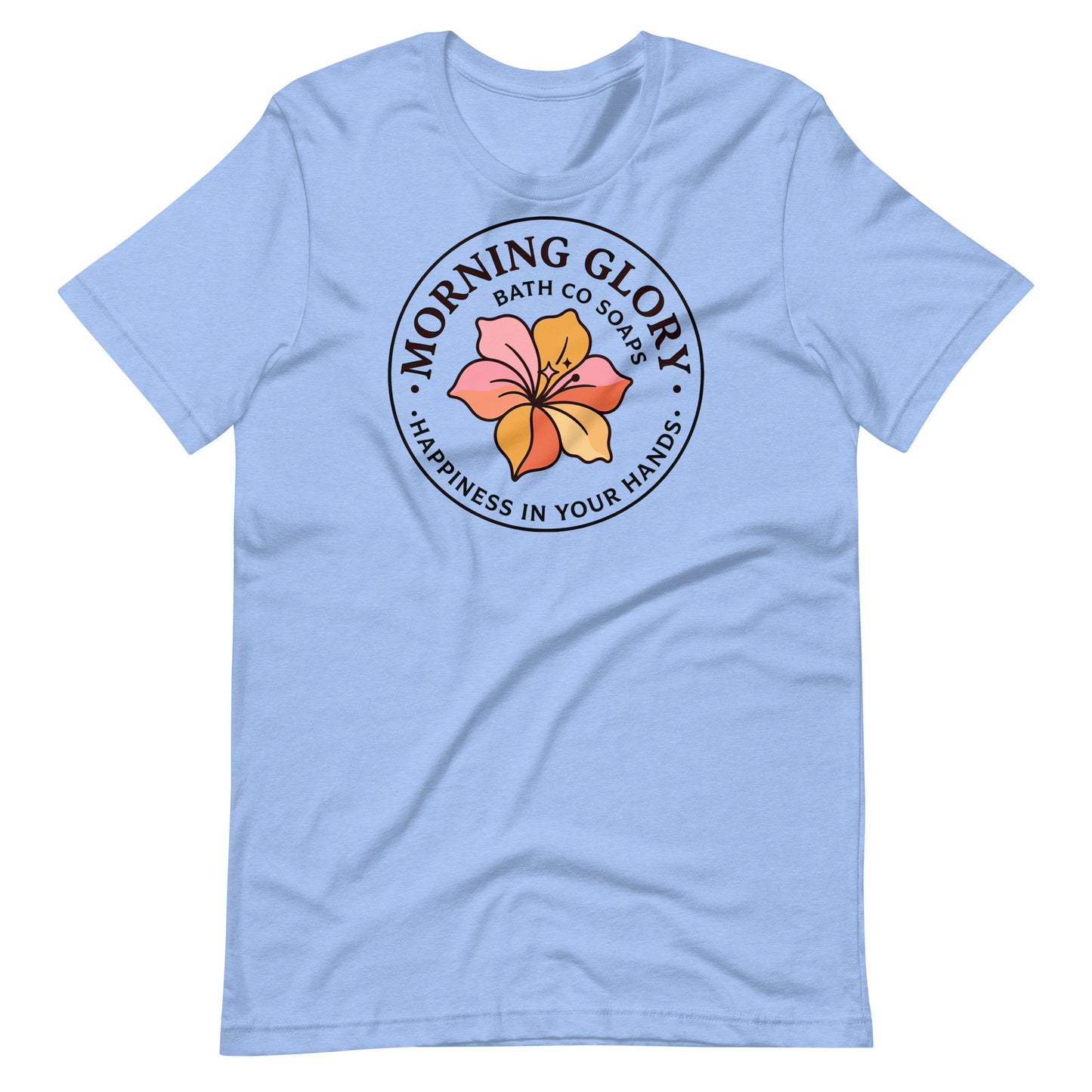 A heather Caroline blue Morning Glory Bath Co t-shirt featuring the circular 'Happiness in Your Hands' floral logo against a plain white background