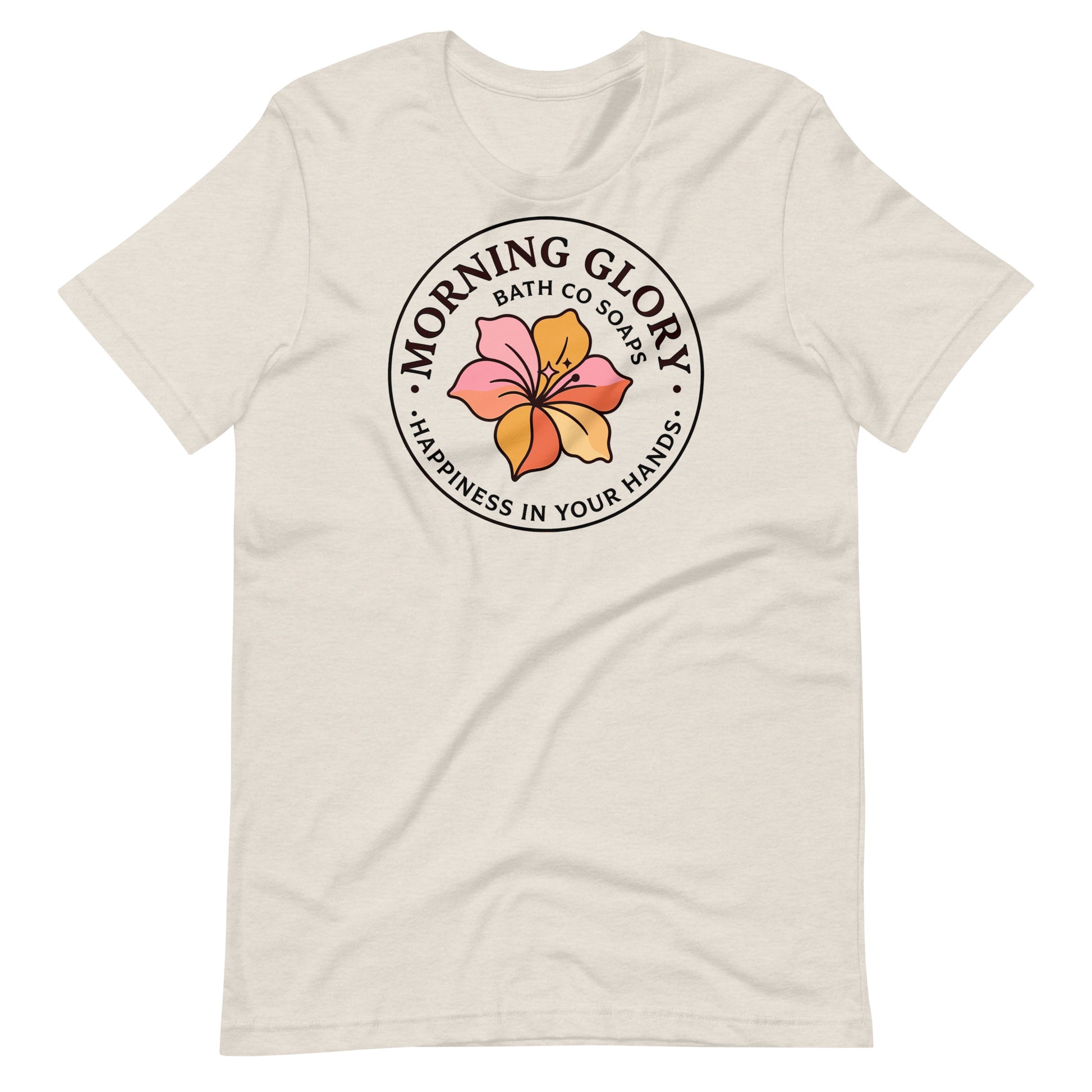 A heather dust Morning Glory Bath Co t-shirt featuring the circular 'Happiness in Your Hands' floral logo against a plain white background